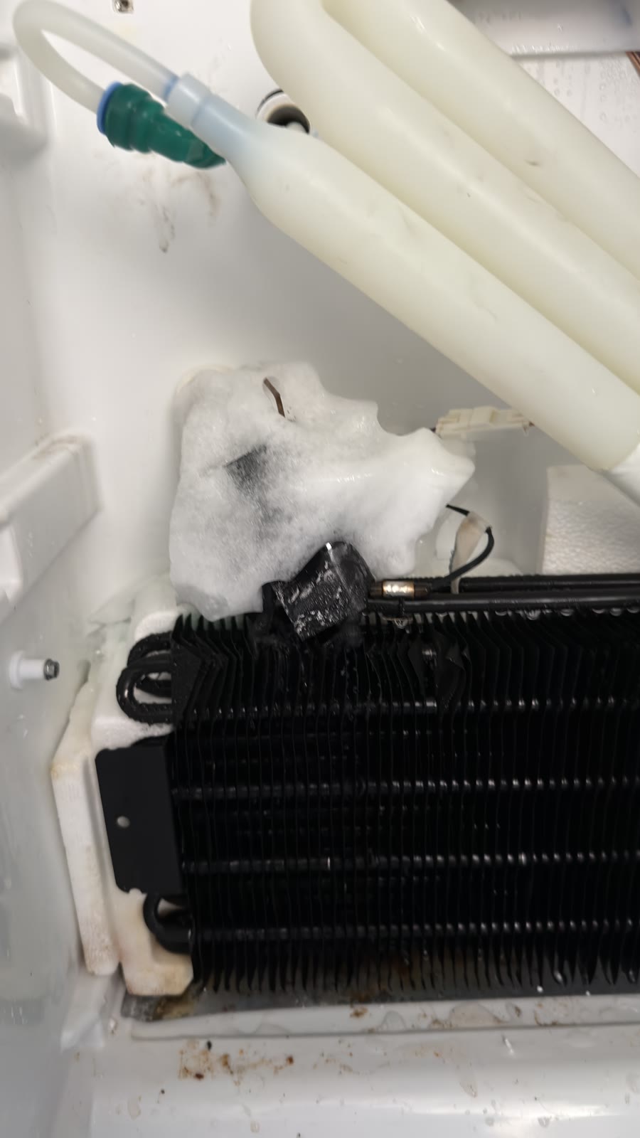 Heavy ice buildup around the Kenmore refrigerator evaporator and fan area