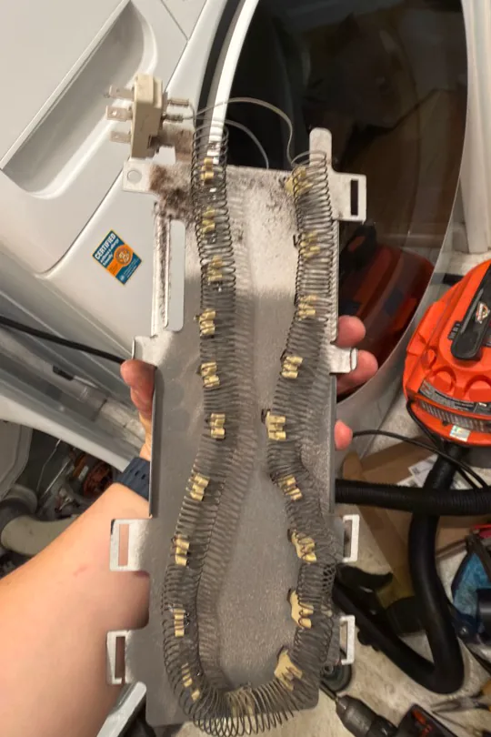 Electric heating element removed from Whirlpool WED8300SW0 dryer during comprehensive repair in Alamo CA