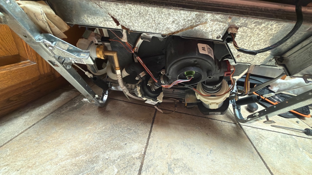 Underside of GE GDT580SSF2SS dishwasher showing drain pump access in Fremont CA