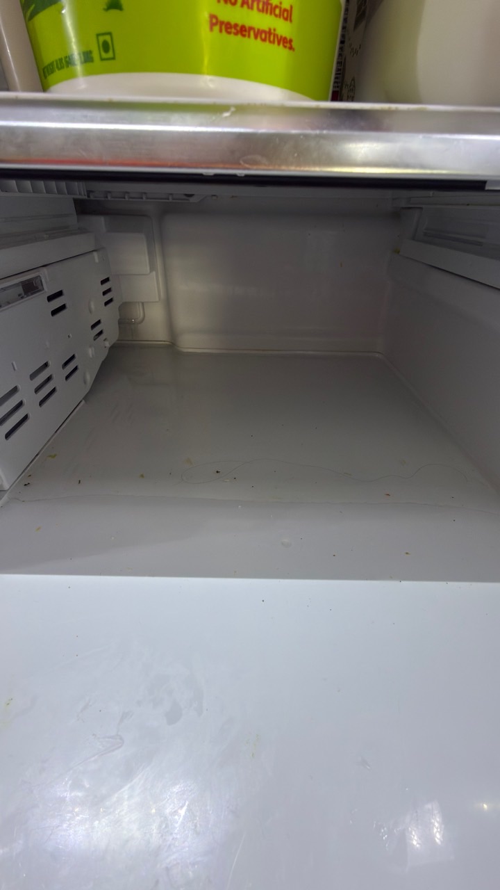 Standing water in Samsung refrigerator fresh-food compartment caused by a clogged drain line in San Ramon CA